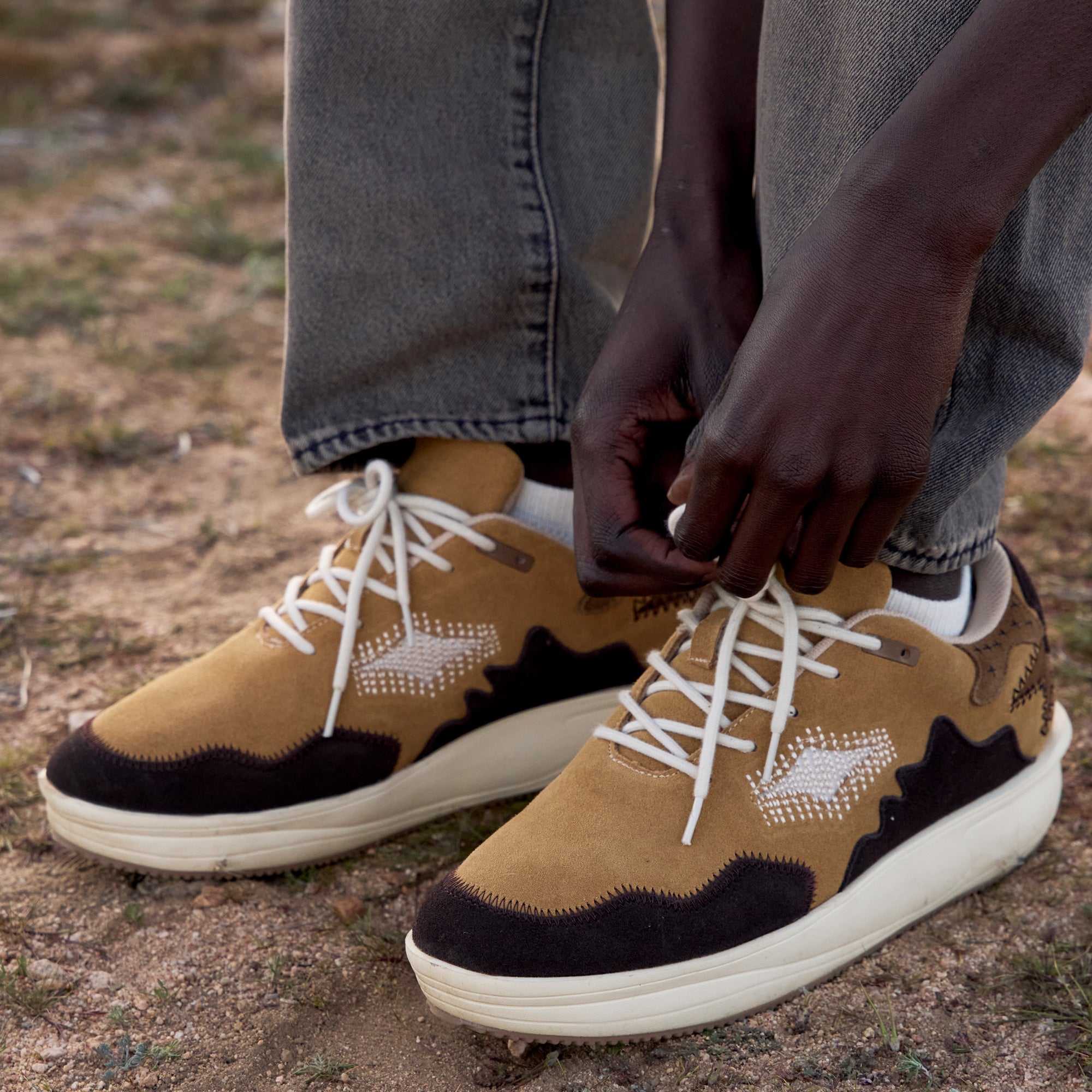 Phase.01 sneakers on foot, lacing detail in outdoor setting
